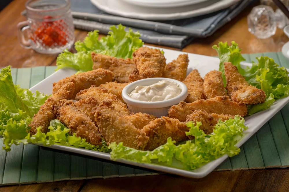 Fried Chicken Strips Coming from Cooking Oil Filter System